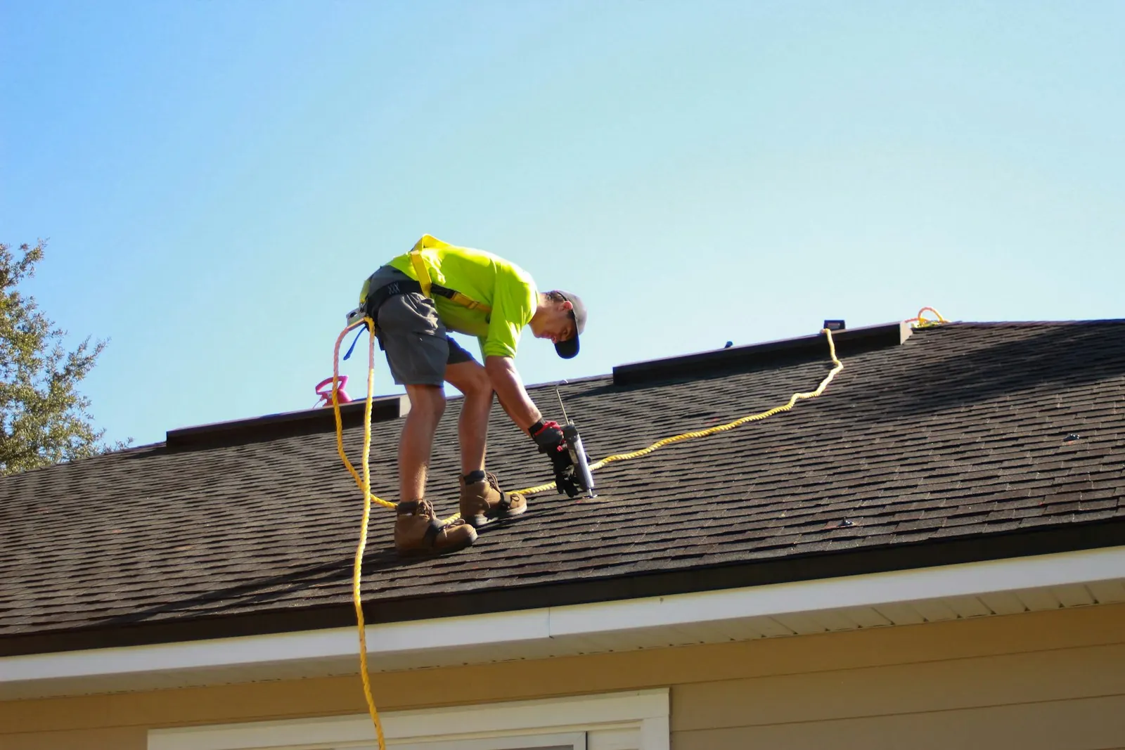 A roofer working on a house roof