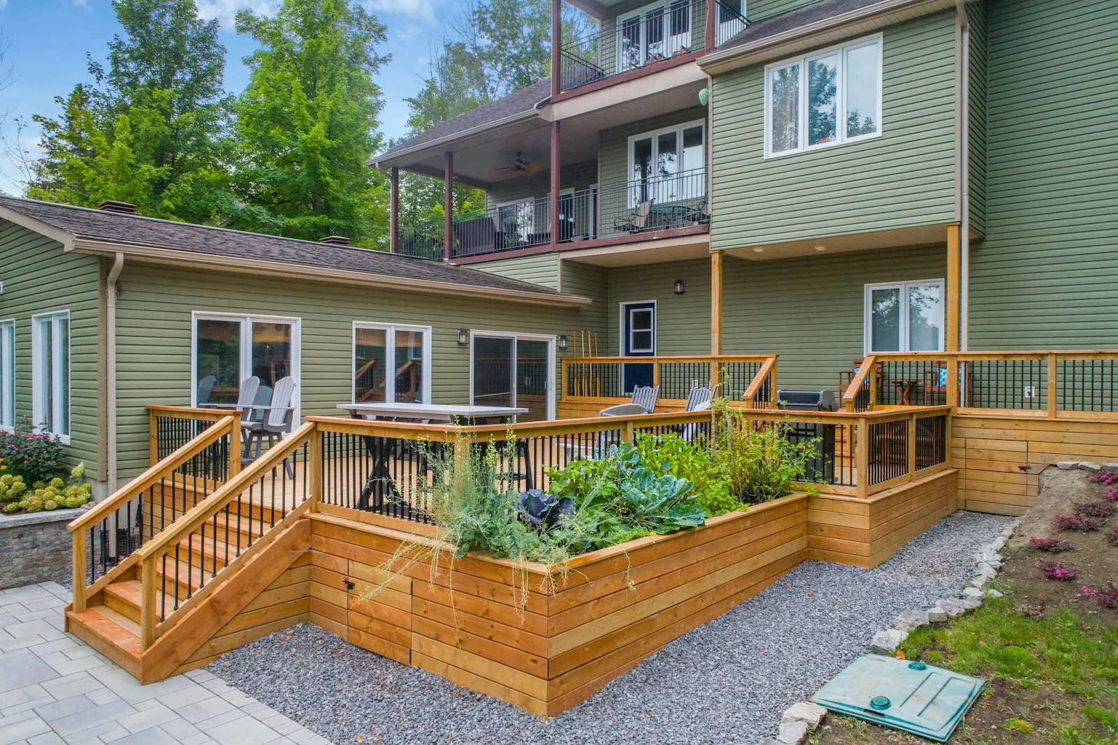 A newly built timber deck with steps and garden beds