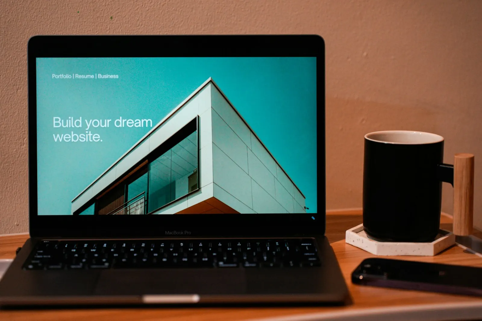 A laptop on a desk showing a website template